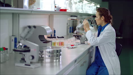 Woman-scientist-start-working-with-microscope.-Microbiologist-looking-microscope